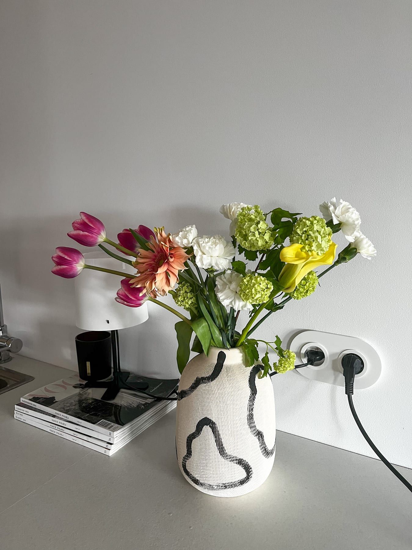 Pink tulips, dahlia and white carnations in a painted vase